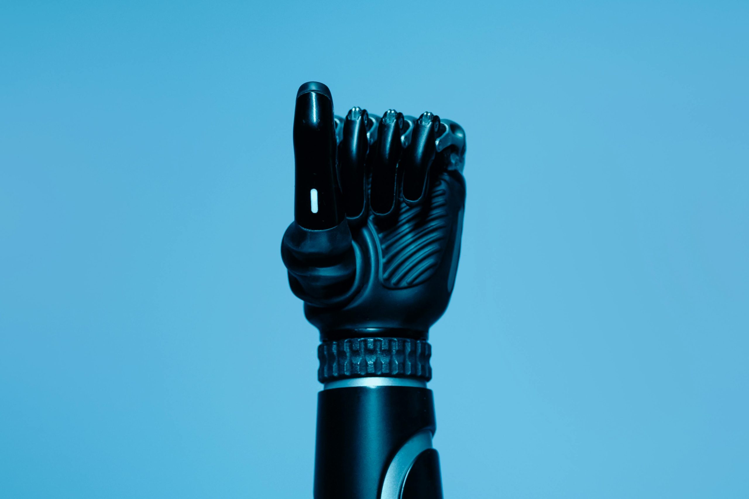 Black carbon fibre prosthetic arm with articulated hand. 