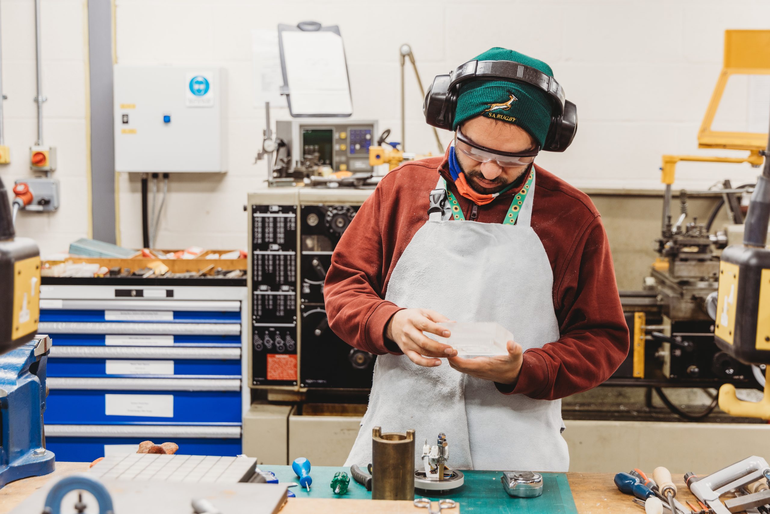 Person with less visible disability in an engineering workshop